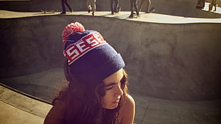 woman wearing blue and red bobble hat