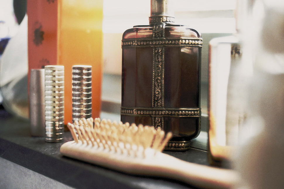 white hair brush beside brown bottle HD wallpaper