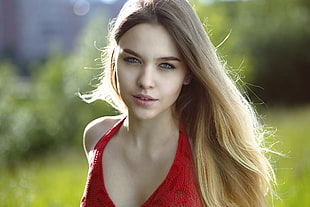 woman wearing red lace halterneck top
