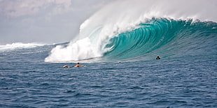 blue ocean waves with people