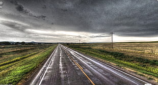 gray asphalt road between green fields of grass under gray cloudy sky during daytime, pan-american, highway 87, montana