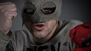 man in gray knitted mask