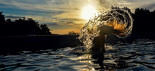 woman on body of water during golden hour HD wallpaper