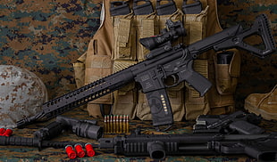 two black assault rifle with scope