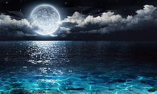 moon above body of water photo