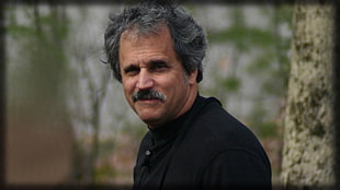 man wearing black top near tree during day