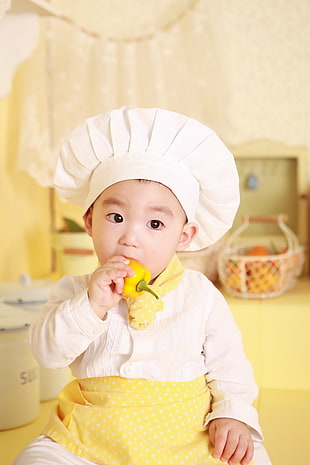 bokeh photography of boy wearing chef costume