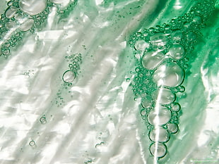 clear plastic with green liquid with bubbles