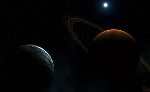 low-light photo of two planets