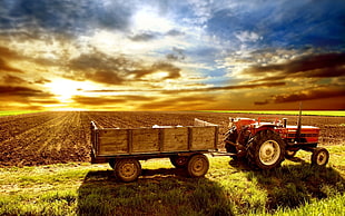 red and black  tractor next to the brown utility trailer painting HD wallpaper