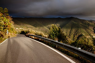 gray concrete road near green mountains
