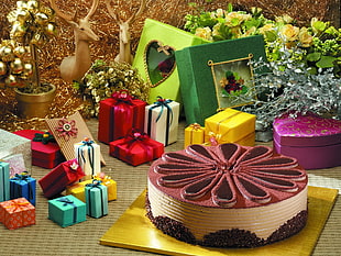 assorted color gift boxes near chocolate cake