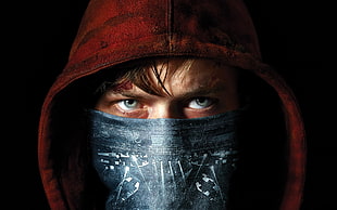 man wearing red hoodie and mouth mask