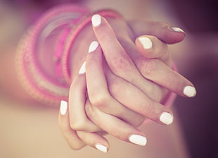 fingers with white nail polish photo