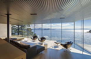 three black armchairs, interior design, far view, sea, window