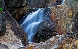 brown and black rock waterfalls