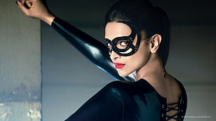 woman in black leather suit and masquerade