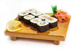 sushis on top of brown wooden platter