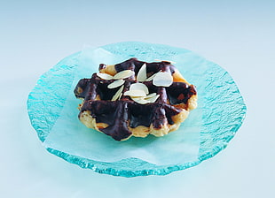 cooked pastry on round blue cut-glass plate
