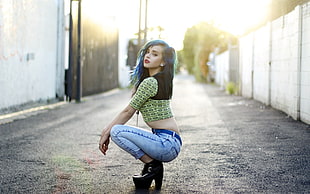 woman wearing yellow crop top and blue jeans