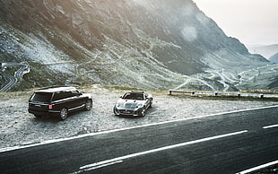 black Maserati Grand Turismo  and black Land Rover Range Rover HD wallpaper