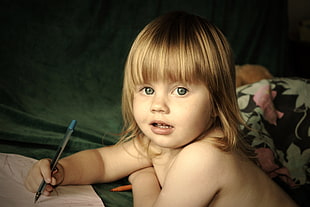 topless girl holding pen
