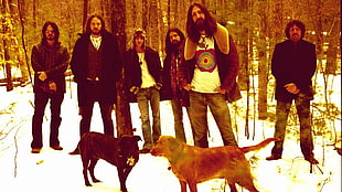 six men standing near two short-coated dogs at daytime