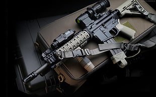 black and grey rifle with scope
