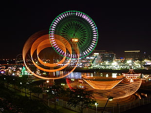 photography of ferris wheel and city