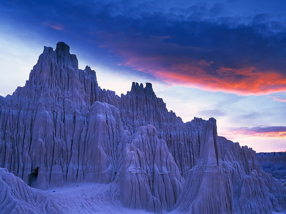 ice covered rock mountain during golden hour HD wallpaper