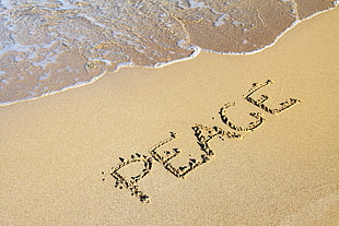 peace word in the beach sand