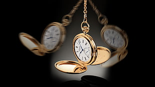 timelapse photography of dangling gold-colored pocket watch HD wallpaper