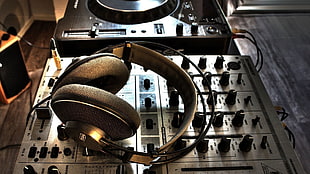 black headphones on gray audio mixer