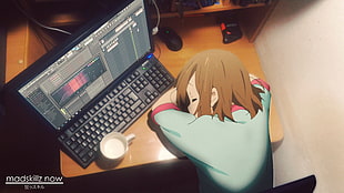 female anime character laying on desk in front monitor and keyboard