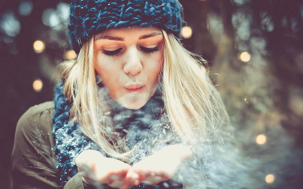 woman wearing winter clothing while blowing snow off her hands HD wallpaper