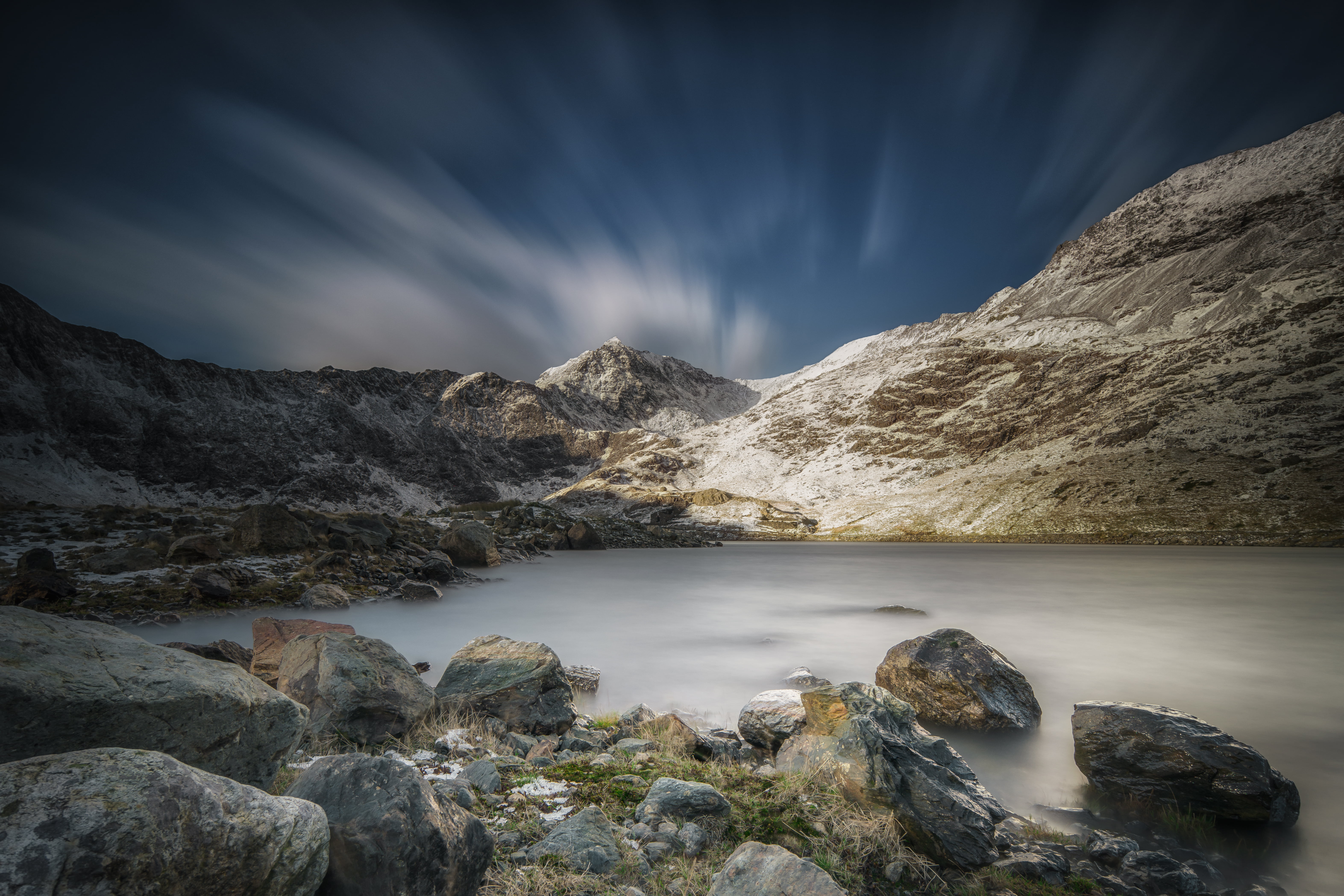 time lapse photography of a body of water surrounded with rocks