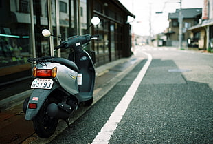 shallow focus photography of silver automatic scooter parking beside high way HD wallpaper