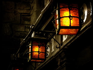 orange outdoor sconces, lantern, dark, building, old building