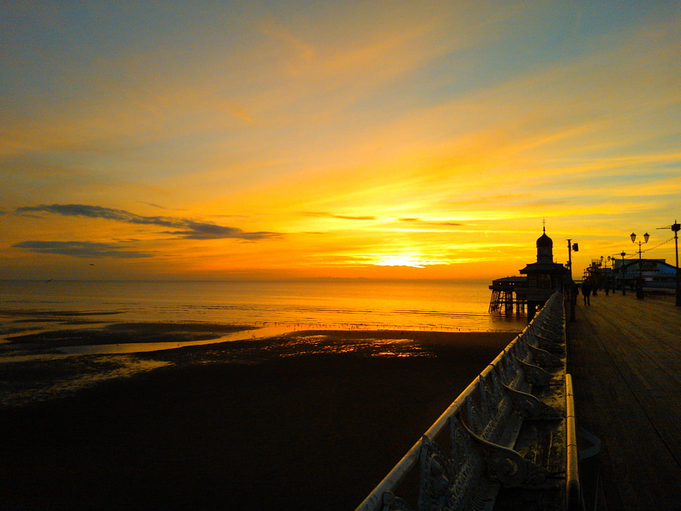 brown and gray building near body of water, sunset, sky, pier, sunlight HD wallpaper