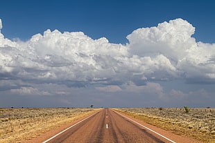 road under cloudy sky during daytime HD wallpaper