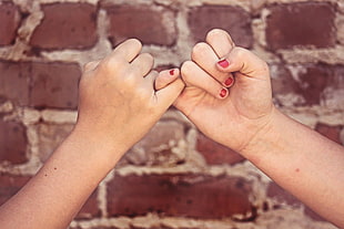 two person pinky swear hand sign