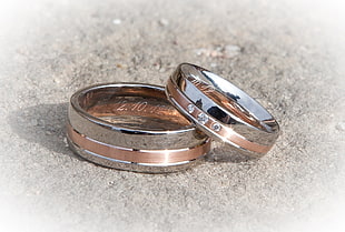 close up photo of rose gold-and-silver couple ring