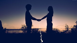 man and woman holding hands during sunset in silhouette photography HD wallpaper
