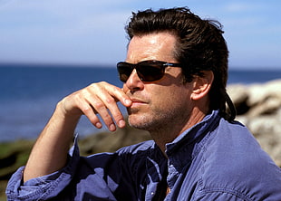 man in black sunglasses near seashore