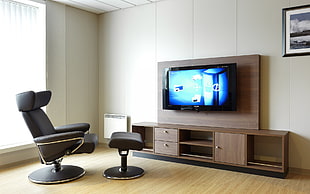 black flat screen TV on brown wooden TV stand HD wallpaper