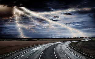 grey road with lightning on the background digital wallpaper