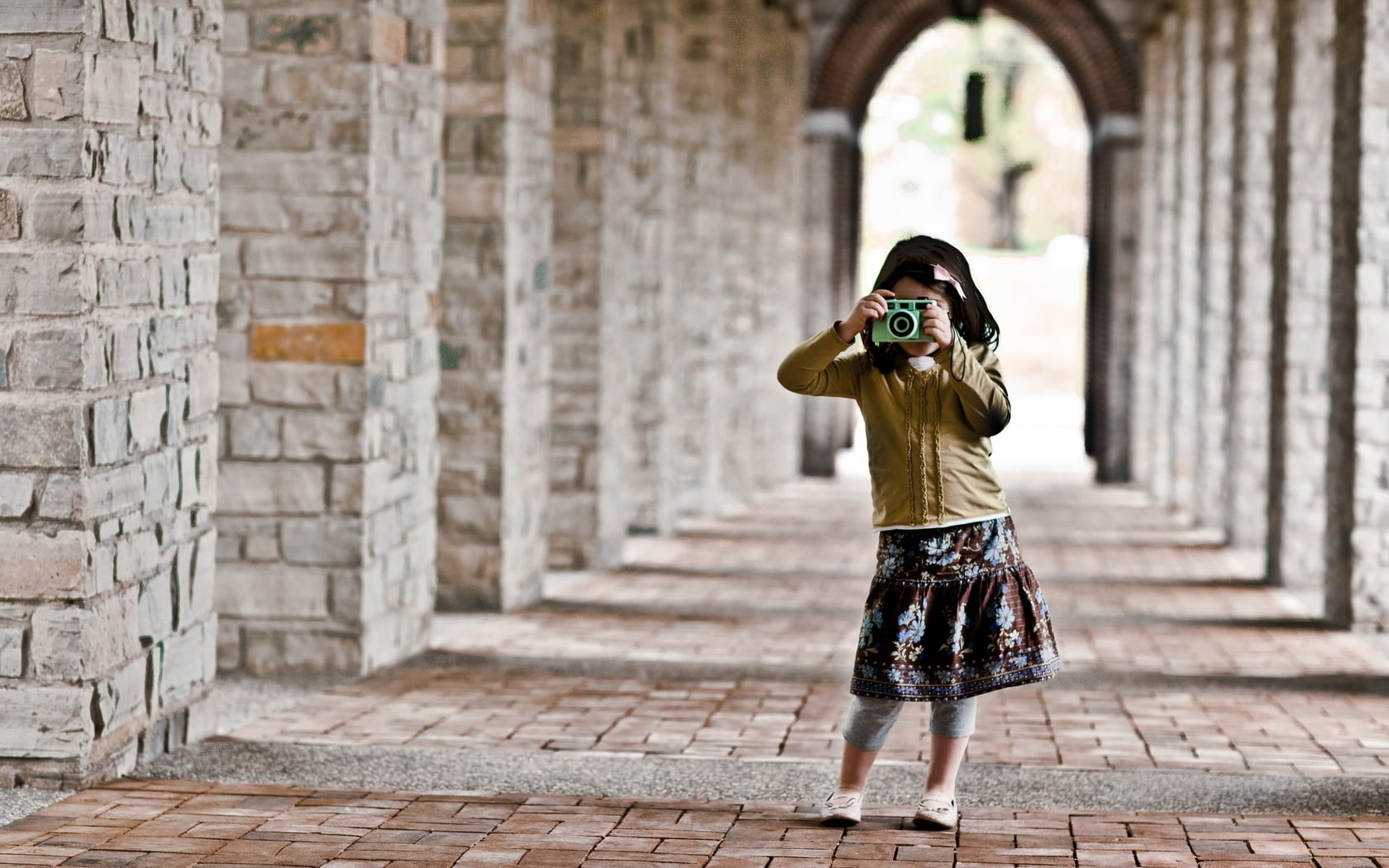 girl in brown leather jacket taking picture