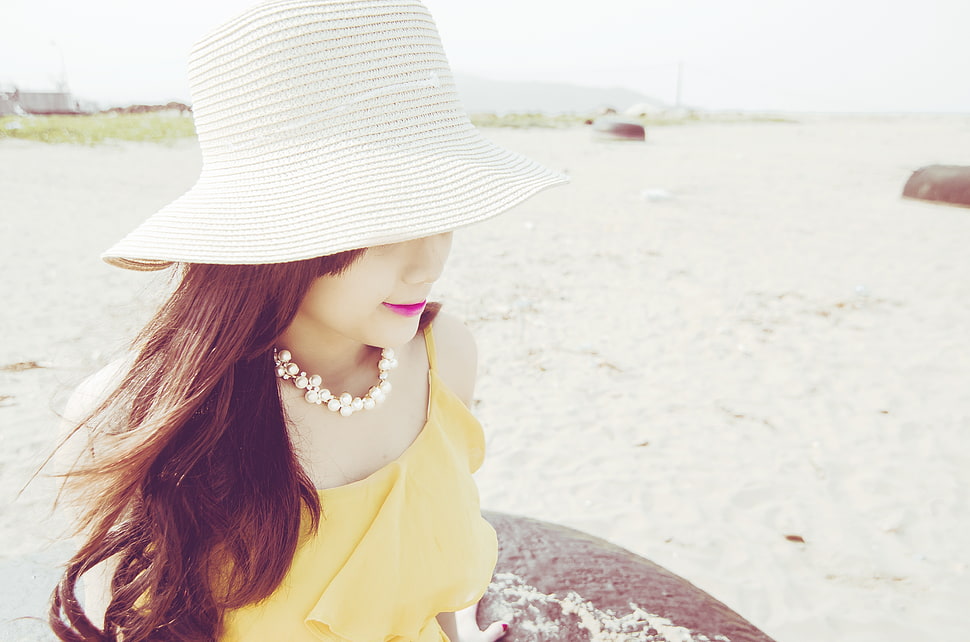 woman in yellow dress wearing sunhat on beach during day time HD wallpaper
