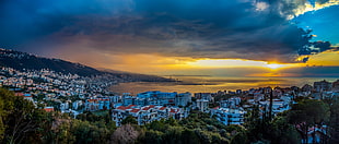 panoramic photography of buildings near sea during sunrise