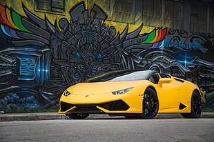 yellow Lamborghini Aventador parked on gray pavement